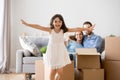 Excited kid girl running over living room enjoying moving day Royalty Free Stock Photo