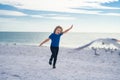 Excited kid running on beach. Little kid boy having fun on Miami beach. Happy cute child running near ocean hunting Royalty Free Stock Photo