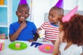 Excited kids enjoying a birthday party Royalty Free Stock Photo