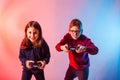 Excited kids with joysticks playing an interesting virtual game