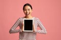 Excited Korean Woman Demonstrating Digital Tablet With Black Blank Screen Royalty Free Stock Photo