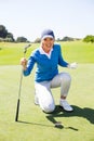 Excited lady golfer cheering on putting green Royalty Free Stock Photo