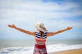 Excited lady in hat spreading hands with joy