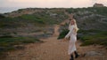 Excited lady stepping chateau landscape. Blonde woman running evening nature