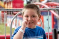 Excited little boy at a colorful carnival