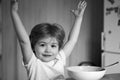 Excited little boy - ecology Food concept. Happy child have a breakfast. Portrait of sweet little laughing baby boy with Royalty Free Stock Photo