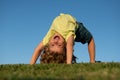 Excited little boy laying on the grass in the park. Outdoor portrait of pretty little boy on fresh green grass. Summer