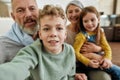 Excited little boy making a selfie with family at home, cheerful grandparent spending time with grandchildren, playing Royalty Free Stock Photo