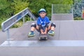 Excited little boy trying out his new skateboard Royalty Free Stock Photo