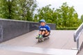 Excited little boy trying out his new skateboard