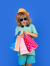 Excited little buyer customer. Child on shopping. Portrait of a kid with shopping bags. Fashion child in shirt