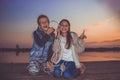 Excited little frinds, singing and listening music together with headphones by the river Royalty Free Stock Photo