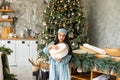 Excited little girl opening christmas present in front of the fir tree Royalty Free Stock Photo