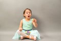 Excited little girl with a plate full of macaroons