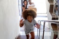 Excited little girl run upstairs exploring new home