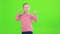 Excited little girl showing fist, shaking hands, while rebelling indoors.