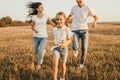 Happy family running in field Royalty Free Stock Photo