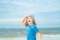 Excited little kid running on the beach, walking on sea sandy beach. Amazed little kid run on sea beach. Travel and Royalty Free Stock Photo