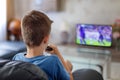 Excited little kid watching soccer match in TV