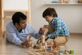 Excited little son and loving indian dad play toys together