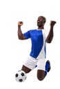 Excited male african american soccer athlete kneeling while celebrating goal over white background Royalty Free Stock Photo