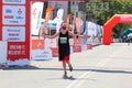 Excited male runner crossing the finshline of a marathon Royalty Free Stock Photo