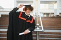 Excited male student in mantle scream graduate from university finish course studying. Happy man triumph holding college Royalty Free Stock Photo