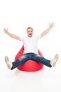 Excited man on bean bag chair Royalty Free Stock Photo