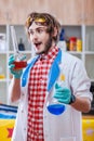 Excited man with chemistry flasks