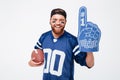 Excited man fan wearing fan glove holding rugby ball. Royalty Free Stock Photo