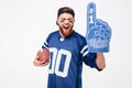 Excited man fan wearing fan glove holding rugby ball. Royalty Free Stock Photo