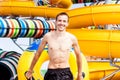 Excited man having fun on water slide in aqua park Royalty Free Stock Photo