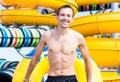 Excited man having fun on water slide in aqua park Royalty Free Stock Photo