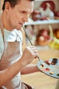 Excited man holding palette and brush Royalty Free Stock Photo