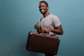 Excited man holding retro briefcase to go on adventure trip Royalty Free Stock Photo