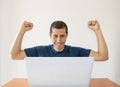 Excited man with a laptop Royalty Free Stock Photo