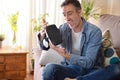 Excited man looking at virtual reality glasses at home Royalty Free Stock Photo