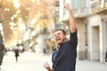 Excited man raising arms celebrating sucess