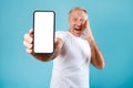 Excited man showing white empty smartphone screen Royalty Free Stock Photo