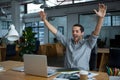 Excited man sitting with laptop at desk Royalty Free Stock Photo