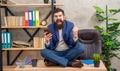 Excited man with smartphone exult in victory making winning gesture sitting on office desk, succeed