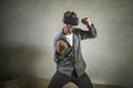 Excited man wearing virtual reality VR goggles headset experimenting 3d illusion playing fight or boxing video game enjoying Royalty Free Stock Photo