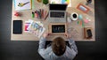 Excited man writing idea on blackboard, full of inspiration to begin working day