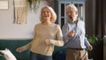 Excited mature couple, man and woman having fun, dancing together Royalty Free Stock Photo