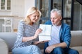 Excited mature man receive box with gift from his loving wife Royalty Free Stock Photo