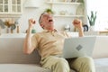 Excited middle aged senior man euphoric winner. Older mature grandfather looking at laptop reading great news getting Royalty Free Stock Photo