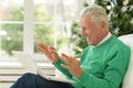 Excited middle aged senior man euphoric winner. Older mature grandfather looking at laptop reading great news getting Royalty Free Stock Photo