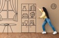 Excited middle eastern lady moving cabinet on interior sketch