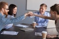 Excited workers join hands engaged in teambuilding activity Royalty Free Stock Photo