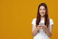 Excited millennial fair-haired woman gaming on smartphone